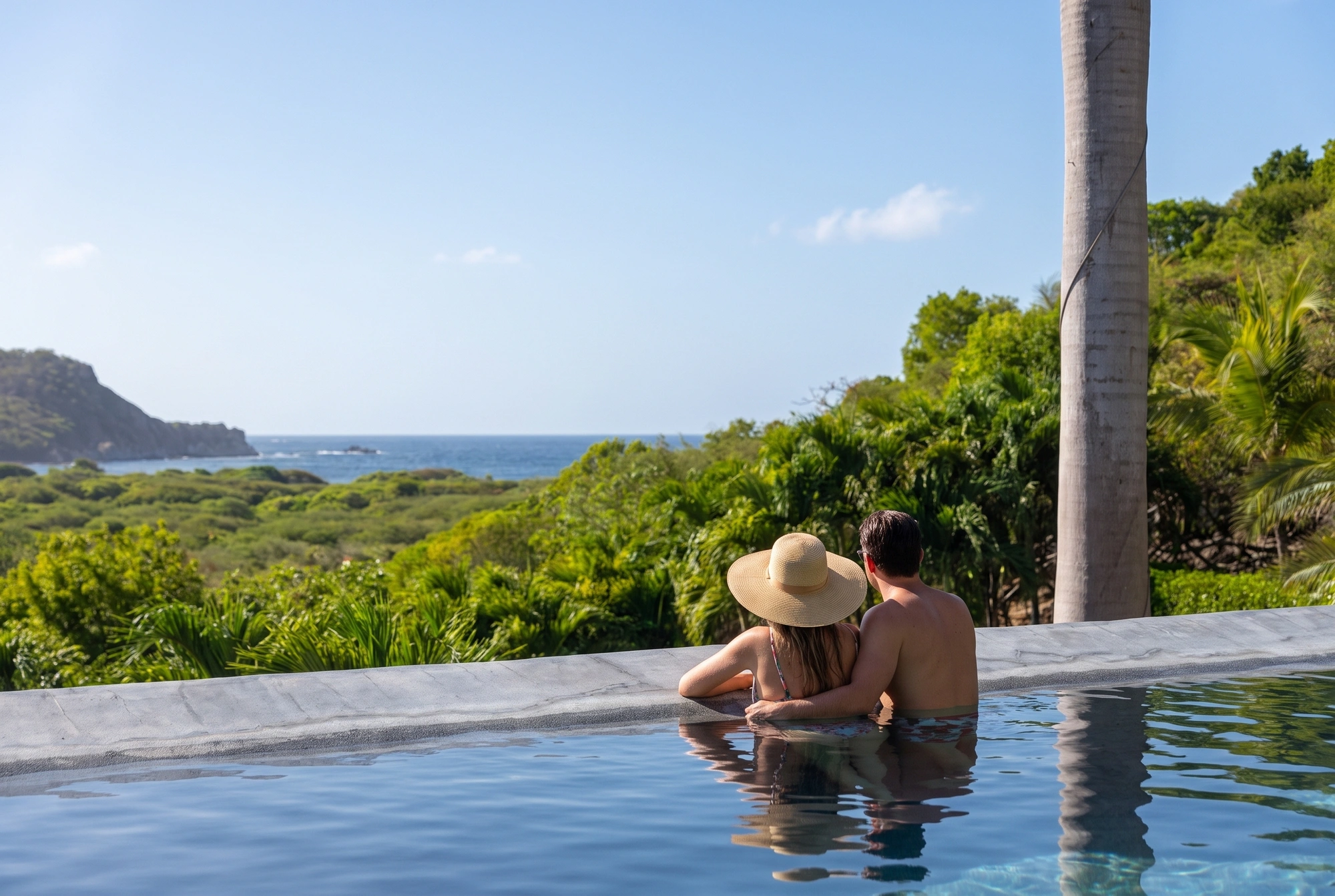 The pool edge, the bay beyond