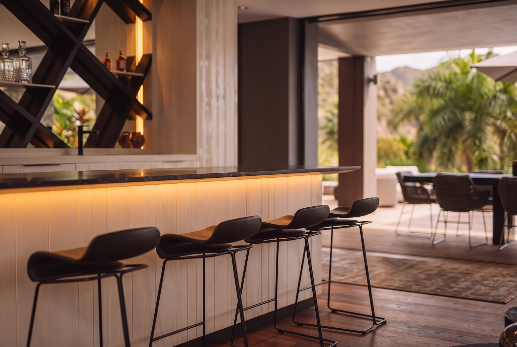 The bar at dusk, its stools along the counter