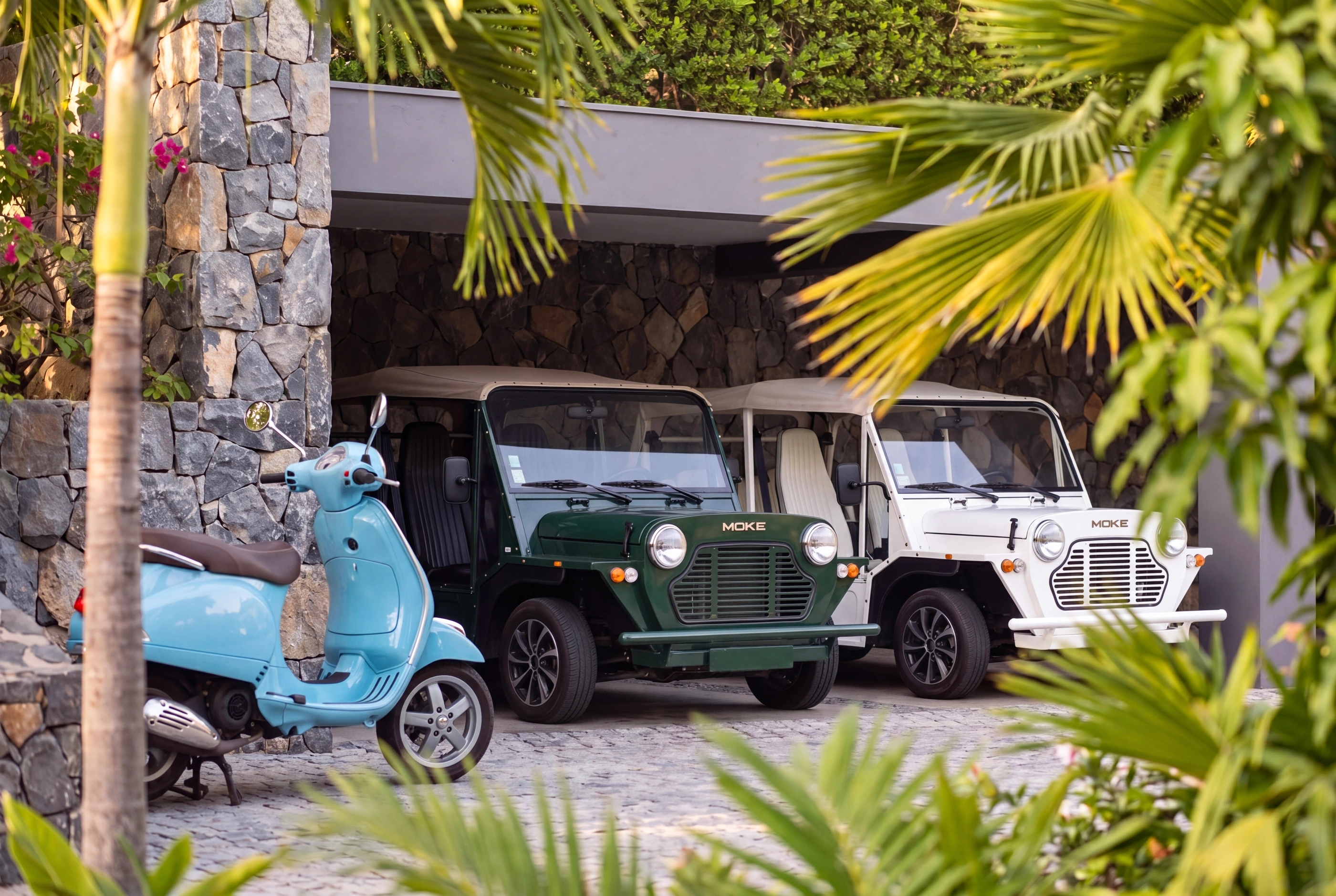 The covered parking, the mokes and a scooter under it