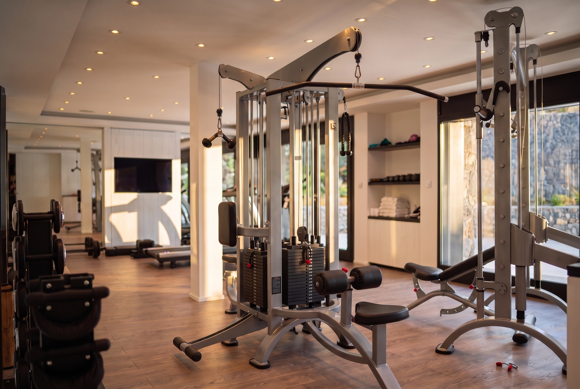 The fitness room, opening onto the stone wall outside